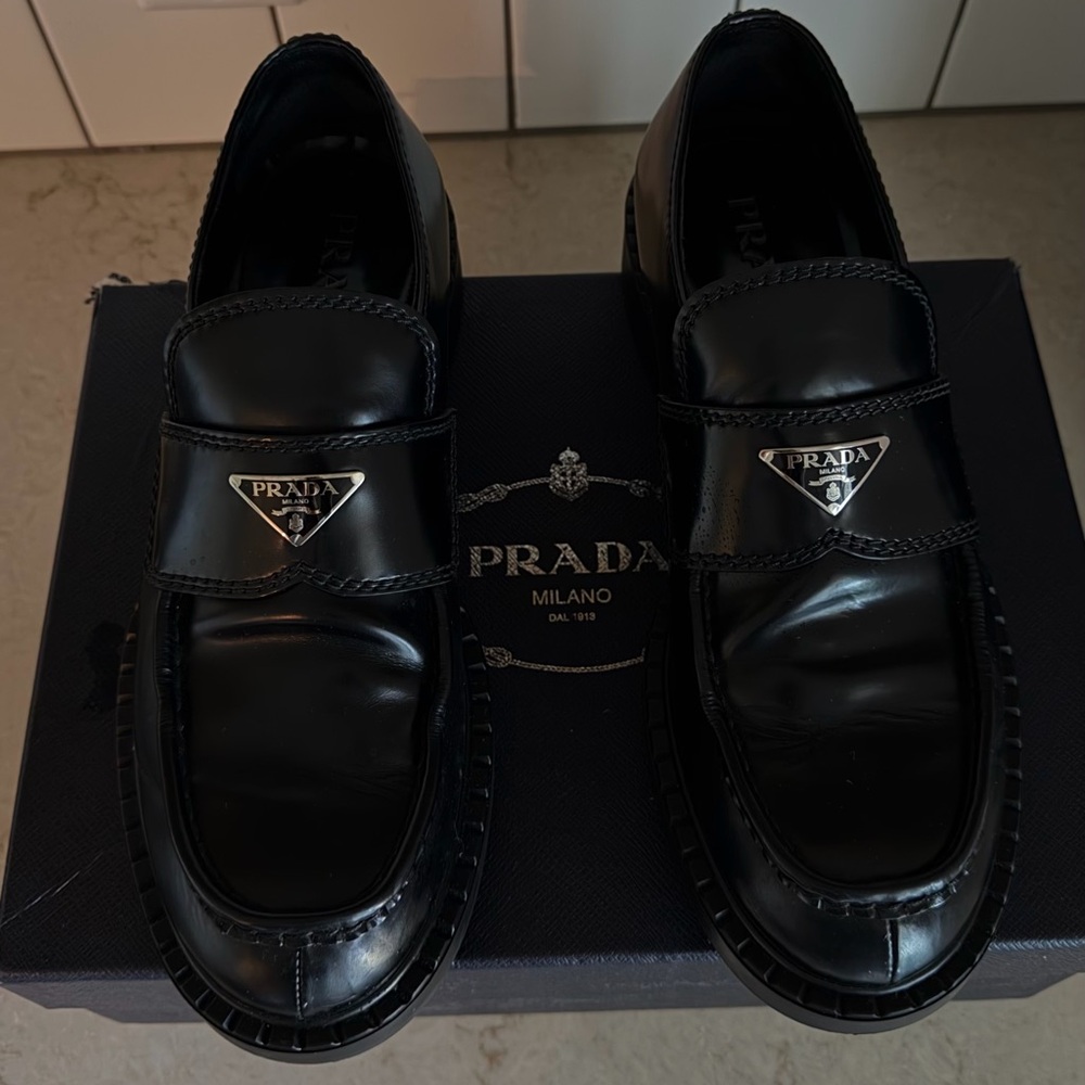 Prada Black Leather Penny Loafers with Silver Logo Plaque